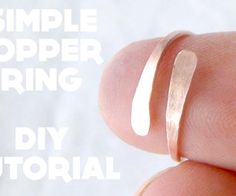 a hand holding a ring with the words simple copper ring on it