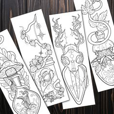 four bookmarks with designs on them sitting next to each other, one has an image of