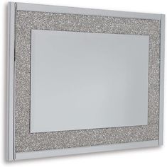 a silver glitter framed mirror on a white wall