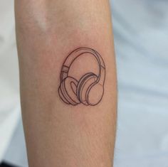 a black and white photo of a person's arm with headphones on it