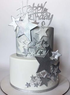 a birthday cake decorated with stars and silver frosting