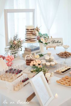 a table topped with lots of cakes and desserts