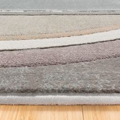 a close up of a rug on a wooden floor with wood floors in the background