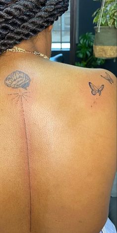 a woman with a butterfly tattoo on her back