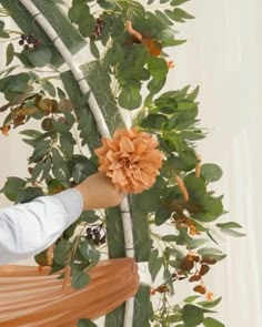 a person holding a flower up to the ceiling