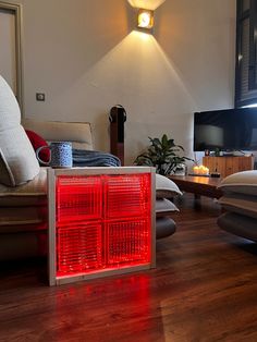 a living room filled with furniture and a red light on top of the heater