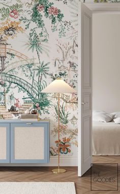 a bedroom with a wallpapered mural next to a blue cabinet and floor lamp