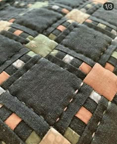 an up close view of a quilt with different colored squares on the back and sides