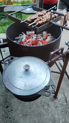 an outdoor bbq grill with food cooking on it