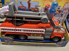 a toy firetruck is in the box on display for kids to play with