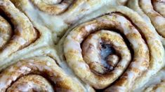 several cinnamon rolls with icing on top of them