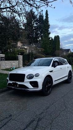 a white suv parked on the side of a road