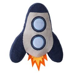 a stuffed toy rocket ship is shown on a white background