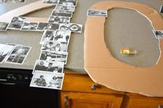 an open cardboard box sitting on top of a counter next to a black and white photo