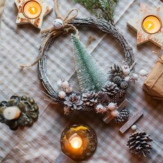 a table topped with candles and other decorations on top of a checkered table cloth