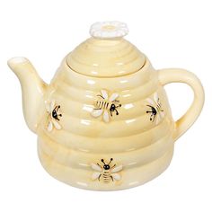 a ceramic tea pot with bees on it