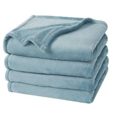 four blue towels stacked on top of each other