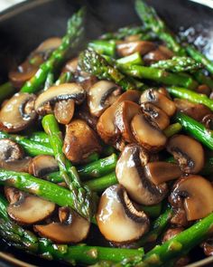 mushrooms and asparagus are in a skillet