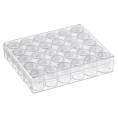 a clear plastic container filled with lots of empty cups on top of a white surface