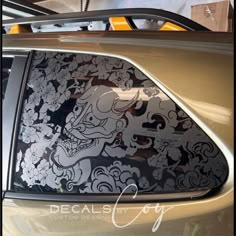 an image of a car that is decorated with flowers and dragon decals on it