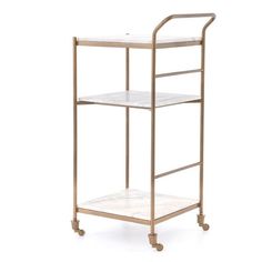 a white marble and brass serving cart with two shelves on each side, against a white background