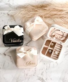 three wedding rings and ring boxes on a marble surface