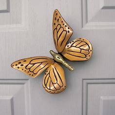 two butterflies are attached to the side of a door