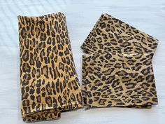 a pair of leopard print napkins sitting on top of a table