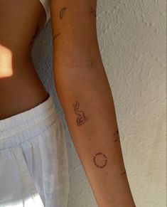 two people with tattoos on their arms and one has a ring around the other arm