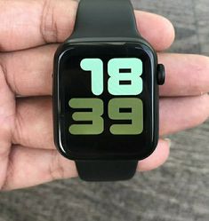 a hand holding an apple watch with the time displayed