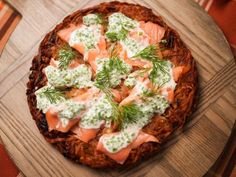 a pizza topped with lots of toppings on top of a wooden board