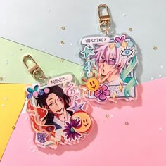 two key chains with anime characters on them