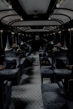 the interior of a train car with blue seats and lights on each side of it