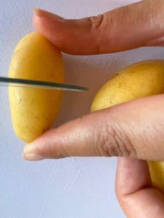 a person is cutting up some fruit with a pair of scissor blades on it