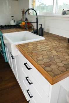 the kitchen counter is made out of hexagonal tiles