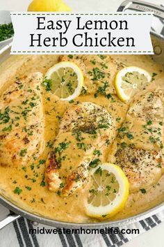 lemon herb chicken in a skillet with herbs and lemons on the side for garnish