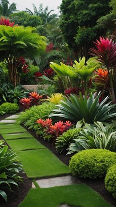 a lush green garden filled with lots of flowers and greenery next to a walkway