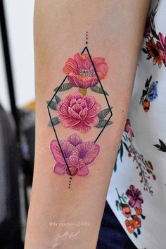 a woman's arm with pink flowers on it and a diamond shaped tattoo design