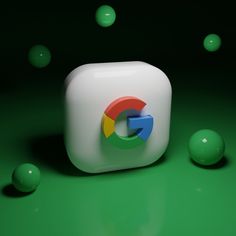 the google logo is surrounded by balls on a green surface with white cubes in the foreground