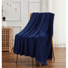 a blue blanket sitting on top of a wooden chair