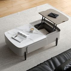 a coffee table with a laptop on it