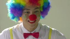 a man with clown makeup and colorful hair