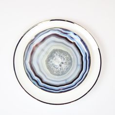 a white plate with blue and black designs on it