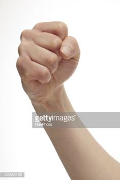 a woman's arm is shown with her fist raised