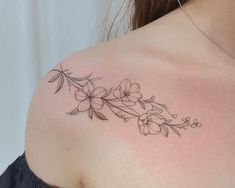 a woman's shoulder with flowers on it, and the back of her arm