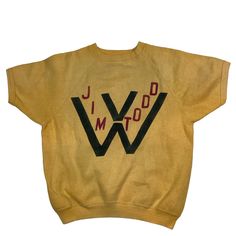 Vintage 1950s/60s Jim Todd ( West Virginia? ) crewneck sweatshirt. High quality. Short sleeve. Tag is missing, measures as a small. 20 inches pit to pit, 22 inches long. Mustard yellow with black and red graphic. No rips or tears, has a couple of faint discoloration flaw as shown in last photo. Rare vintage find. Smoke and pet free home. Retro Crew Neck Sweater With Letter Print, Vintage Cotton Sweatshirt With Graphic Print, Vintage Yellow Cotton Sweater, Retro Cotton Crew Neck Sweater, Retro Crew Cotton Sweater, Retro Cotton Crew Sweater, Retro Cotton Sweatshirt, Yellow Retro Cotton Sweatshirt, Retro Yellow Cotton Sweatshirt