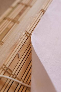 a piece of paper sitting on top of a bamboo mat next to a wooden board