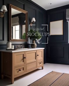 a bathroom with black walls and wooden furniture, including a large mirror over the sink