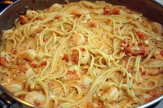 pasta with shrimp and tomato sauce in a pan