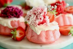 strawberry shortcakes with white frosting and fresh strawberries on the top, ready to be eaten